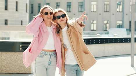 two happy women strolling in the city