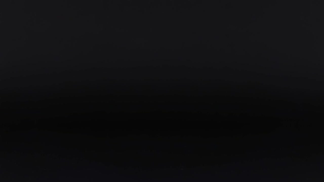 An orange ball moves across a dark, grid-like background, showcasing dynamic motion and visual patterns.