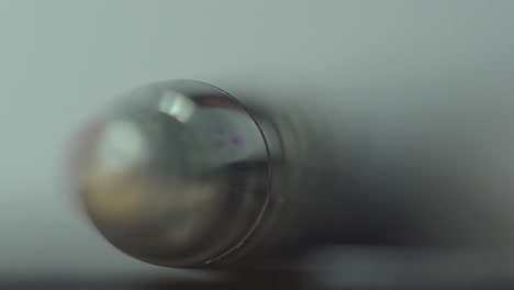 Ball-point-pen-isolated-rack-focus-extreme-close-up-dimly-lit-area