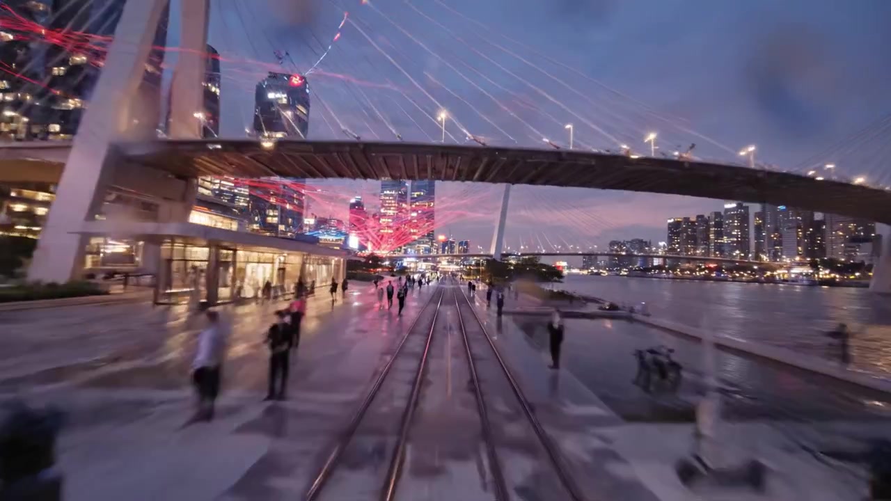 Captivating Nightscape of a City Skyline with Vibrant Light Trails, Modern Architecture, and a Scenic Waterfront Setting Under a Twilight Sky