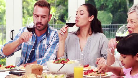 Happy-family-toasting-during-lunch