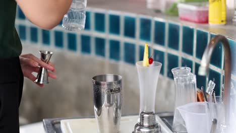 bartender skillfully mixes ingredients for a cocktail