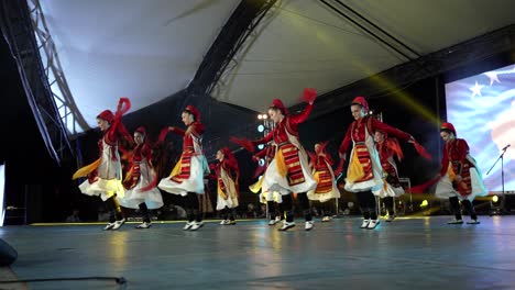 women dressed in beautiful traditional clothes dancing albania folk music in stage