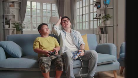 asian man and son are encourage each other after lost the game