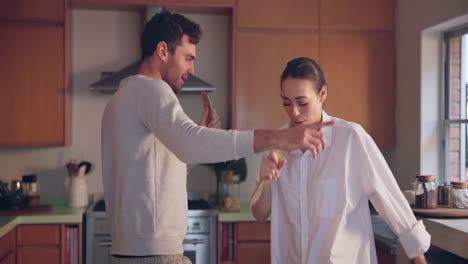 singing, smile or happy couple in home kitchen