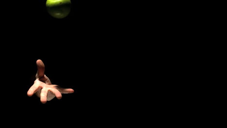 hand throwing a green apple in the air