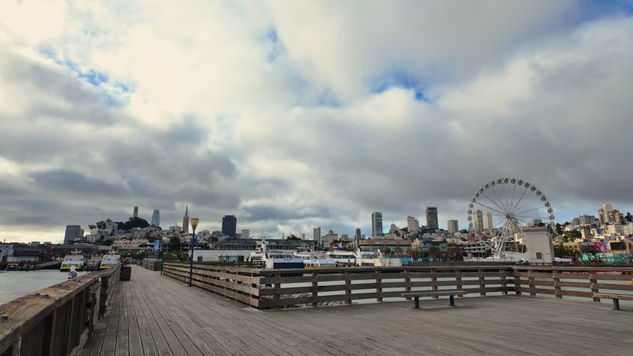 Walking on Pier 41 with San Francisco skyline and SkyStar Wheel in the background
