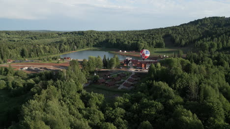 aerial view of mountain resort with hot air balloon