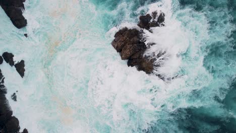 Overhead-View-Of-Foamy-Waves-Breaking-On-Outcrops-In-Caion-Beach,-Coruna-Spain