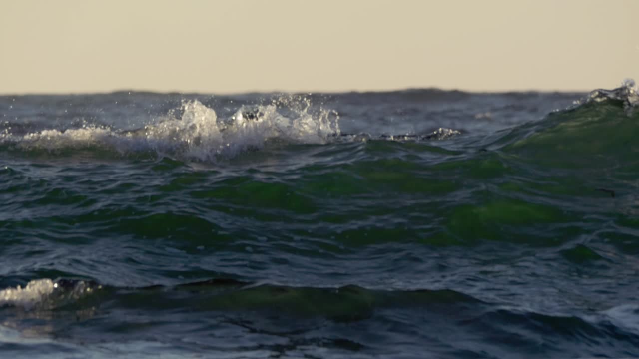 Ocean surface waves in sunny afternoon. Close Up. Slow Motion 120 fps.