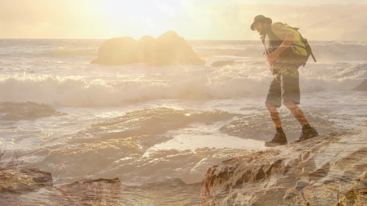 Male hiker navigating rocky coastal shoreline at sunset, with animated travel route overlay
