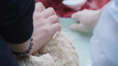 close-up of kneading bread by a woman