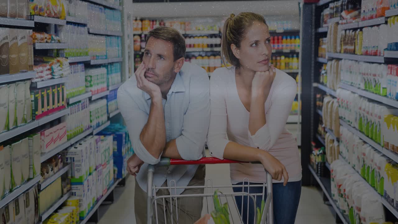 Couple leaning on cart, scanning grocery shelves, initiating digital overlays obscuring view