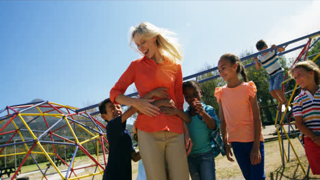 Trainer-and-schoolkids-having-fun-in-playground