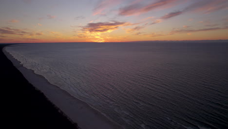 Golden-sunset-aerial-view-slow-descending-across-Krynica-Morska-on-the-Baltic-Sea-in-Poland