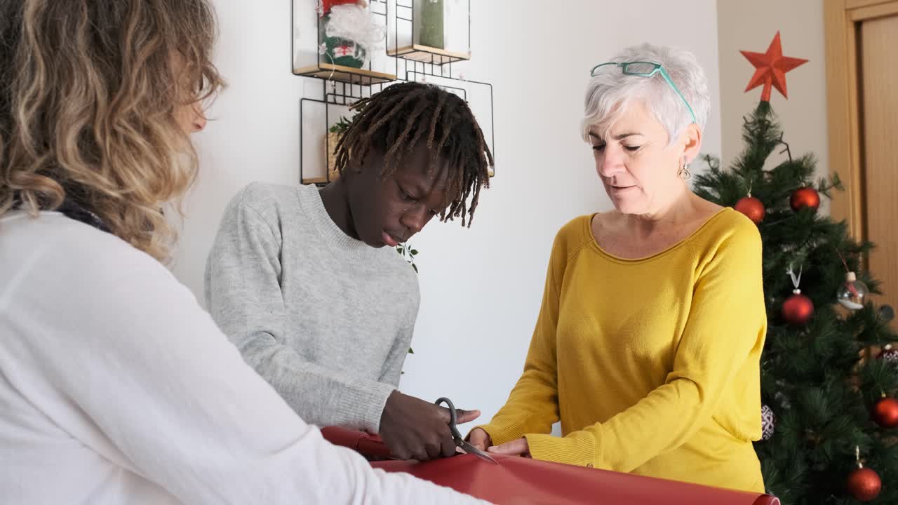Family wrapping Christmas gifts