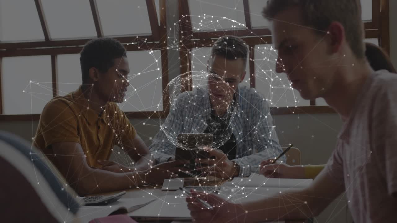 Network sphere appearing above table, students examining smartphone data and taking notes in study