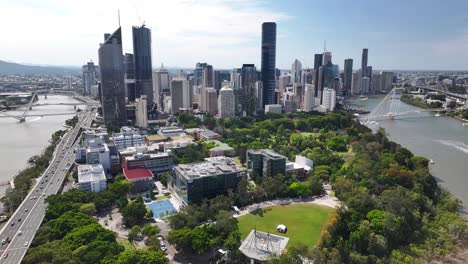 traffic on the bridge to brisbane and downtown over city botanic gardens. aerial birds eye view.