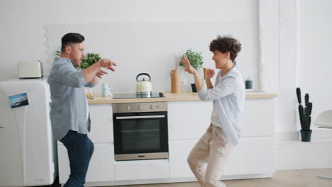 happy couple dancing in the kitchen
