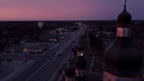 orbiting from main street church in foreground sunset