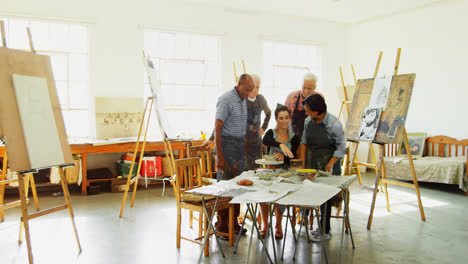 woman assisting artists in pottery 4k