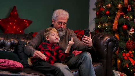 grandfather and grandchild making a christmas selfie