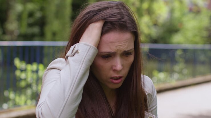 Close Up Of Depressed Woman Outdoors With Financial Worries About Cost Of Living Crisis Debt And Paying Bills On City Street 2