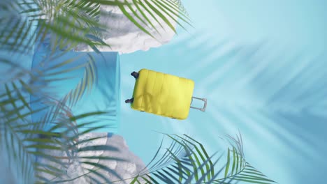 yellow trolley travel suitcase ready for a holiday in tropical environment vertical shot