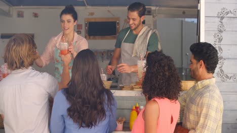 Smiling-waiter-and-waitress-taking-order-from-customer