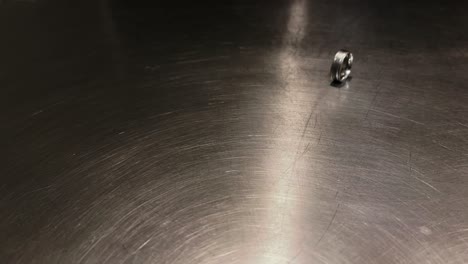 Wedding-Ring-Rolls-Across-Countertop,-Divorce-Close-Up