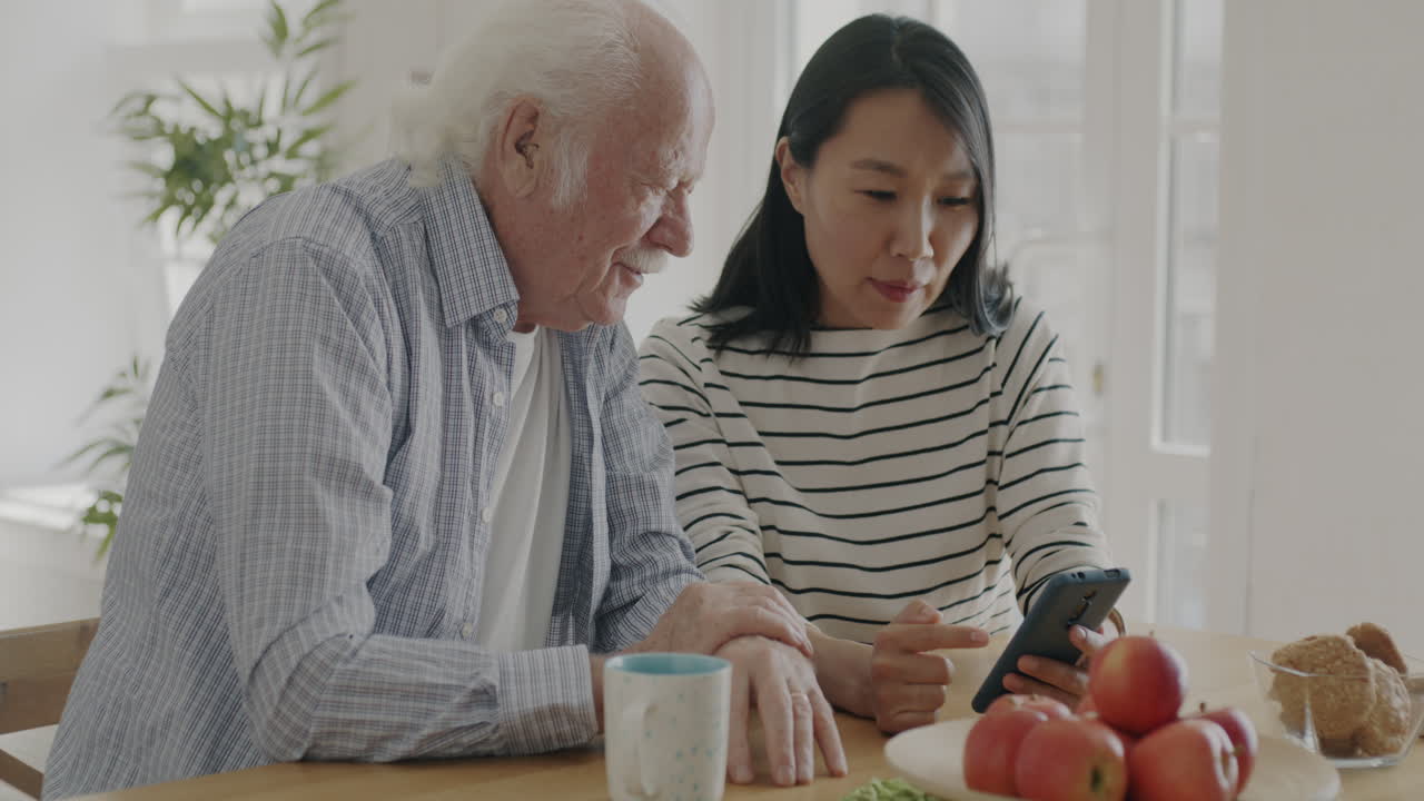 Elderly Man and Woman Using Smartphone