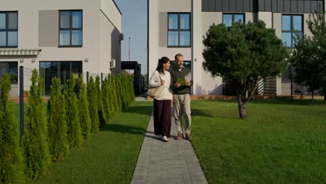 couple walking and discussing property details