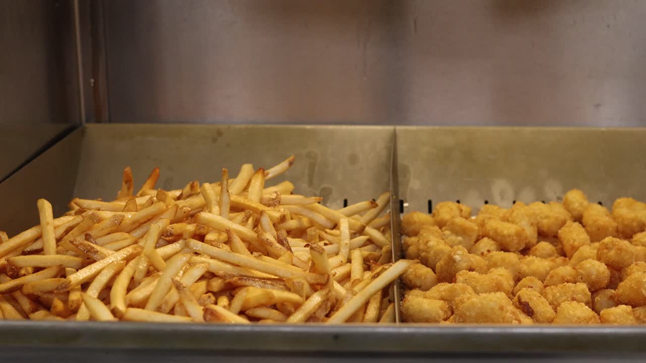 Fresh Batch Of French Fries Getting Seasoned