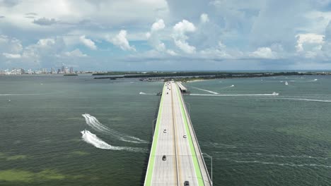 timelapse video of key biscayne bridge with boats going under the bridge and cars driving over bridge in miami florida
