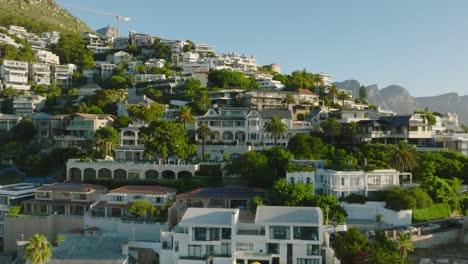 slider of luxurious houses in sunny slope. fly above tropical tourist destination. cape town, south africa