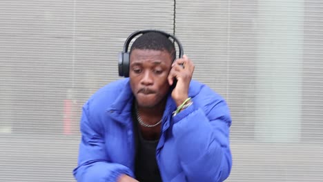 black man listening to music in city