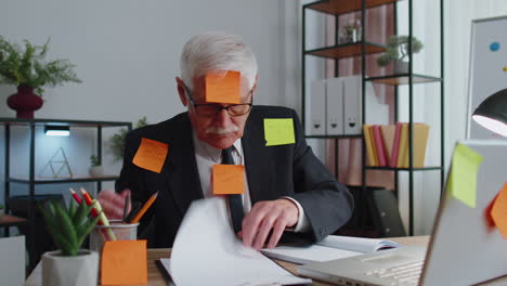 tired exhausted senior business man office manager with laptop sticky notes sticks with many tasks