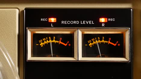 analog vu meter of a vintage tape recorder machine while recording