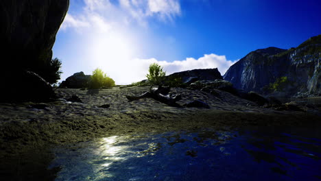 sunrise over rocky landscape with reflections in calm water