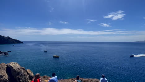 A-mesmerizing-video-of-Madeira's-coastline-showcasing-the-rocky-cliffs,-turquoise-sea,-and-crashing-waves