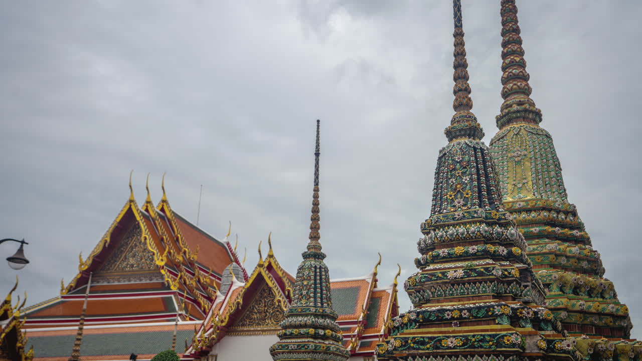 Wat Pho Temple, Bangkok Thailand. Time Lapse of Rainy Clouds Above Buddhist Stupas and Ornaments