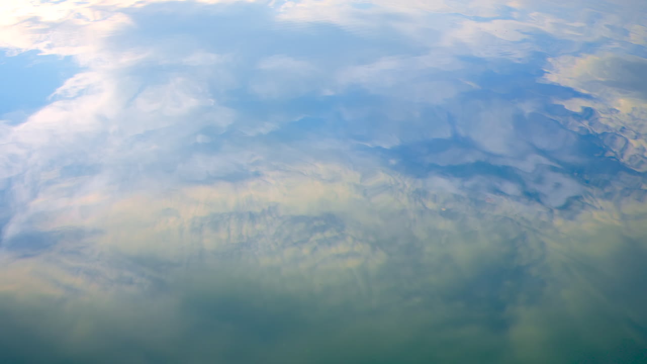 View of a water surface with blue sky reflected in it