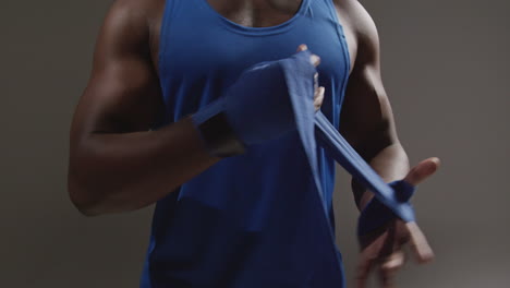 a black male boxer wrapping his hands