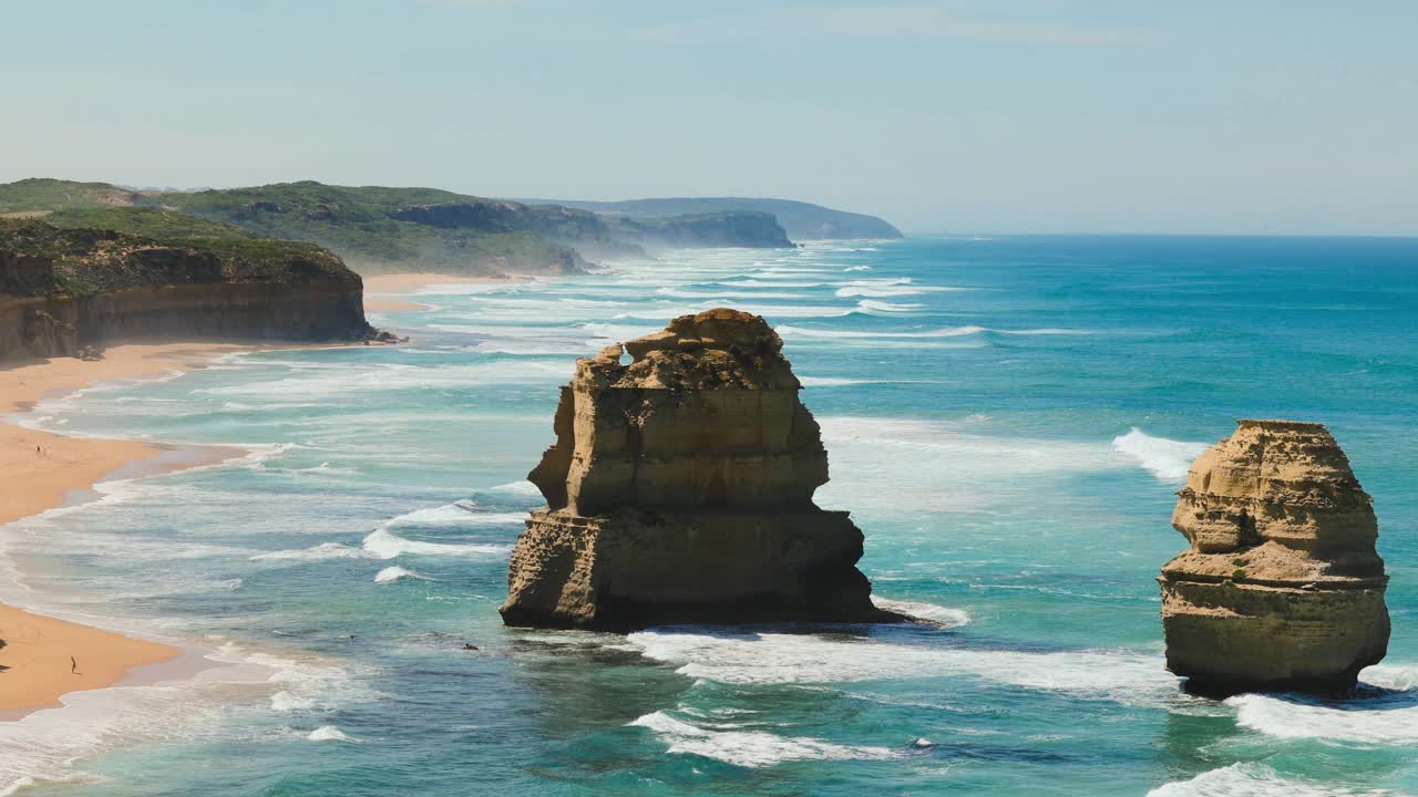The iconic 12 Apostles of the Great Ocean Road of Melbourne, Australia. Strong Waves approach the rock formations and Gibson Beach.