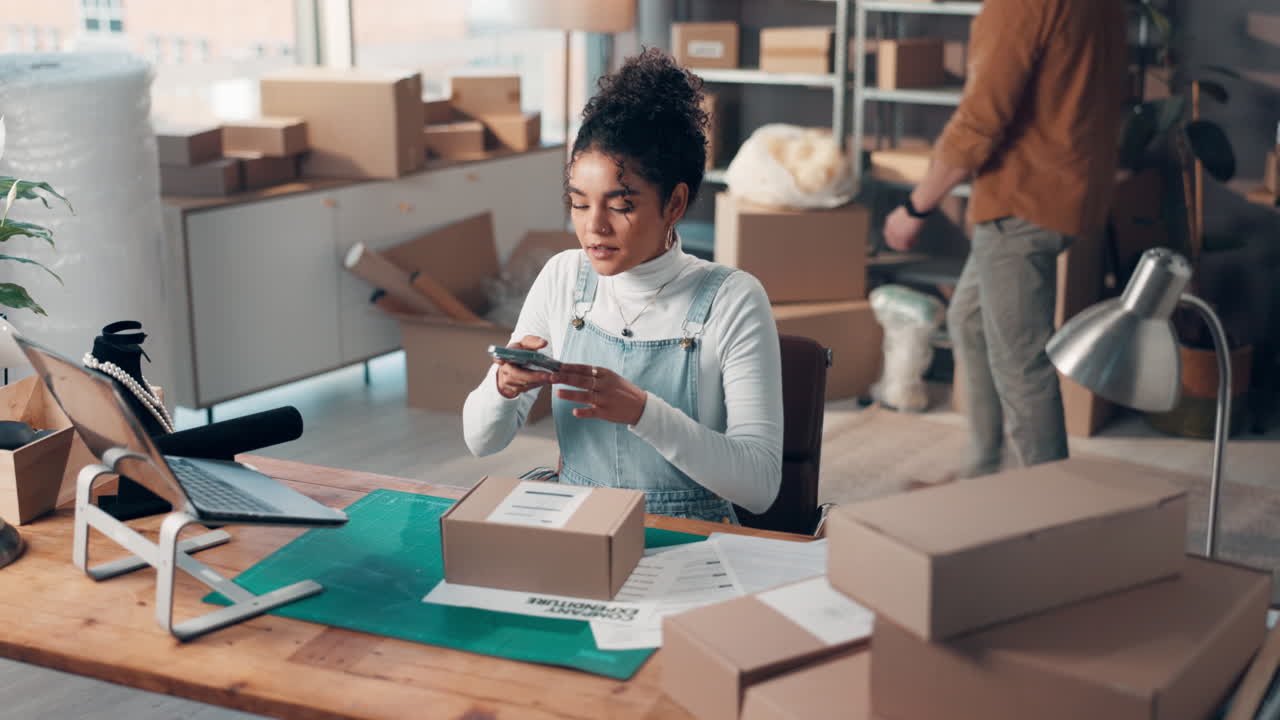 Woman taking photos of packages for her small business