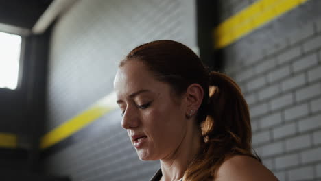 woman drinking water after workout