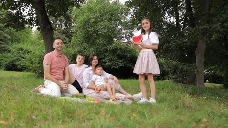 happy family clinking glasses enjoying picnic in park happy family clinking glasses enjoying ice lemonade during picnic in park on sunny weekend day
