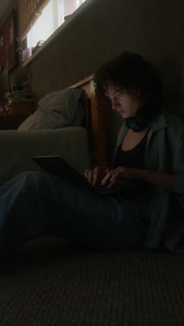 woman working on a laptop in a bedroom