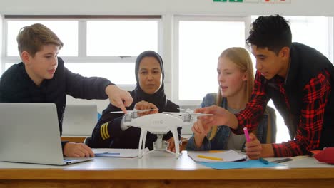 Female pilot giving training about model drone to kids 4k