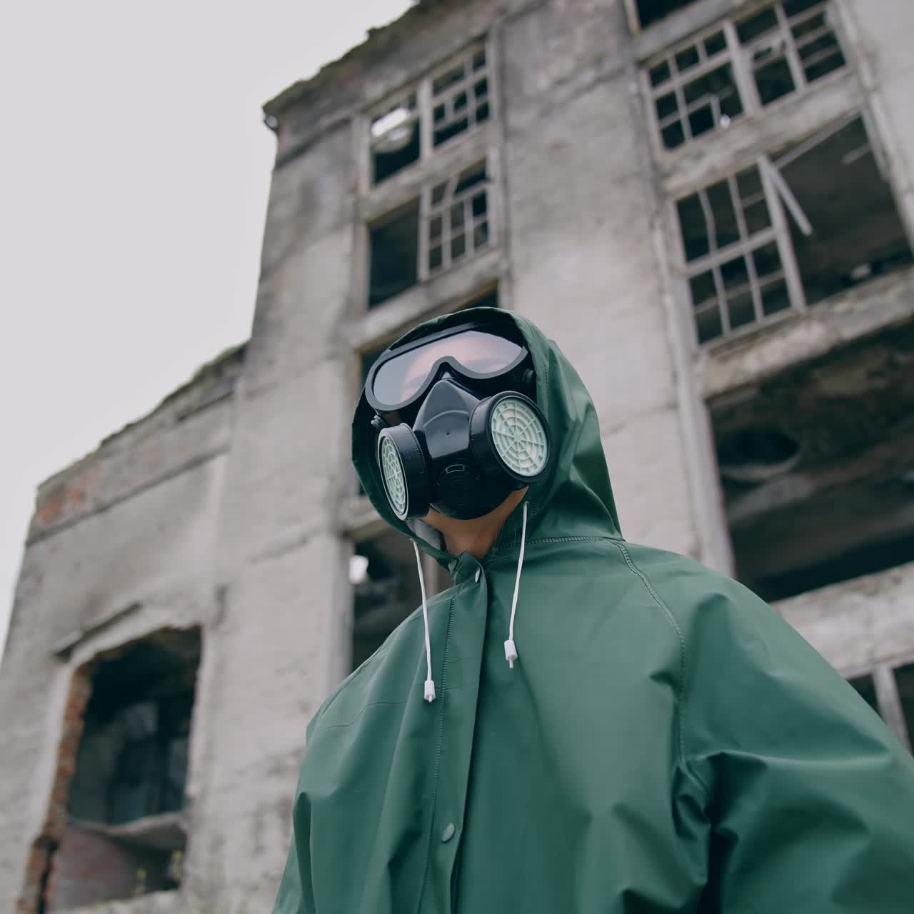 Human in radioactive hazmat standing in apocalypsis city. Protective ecology in radioactive mask